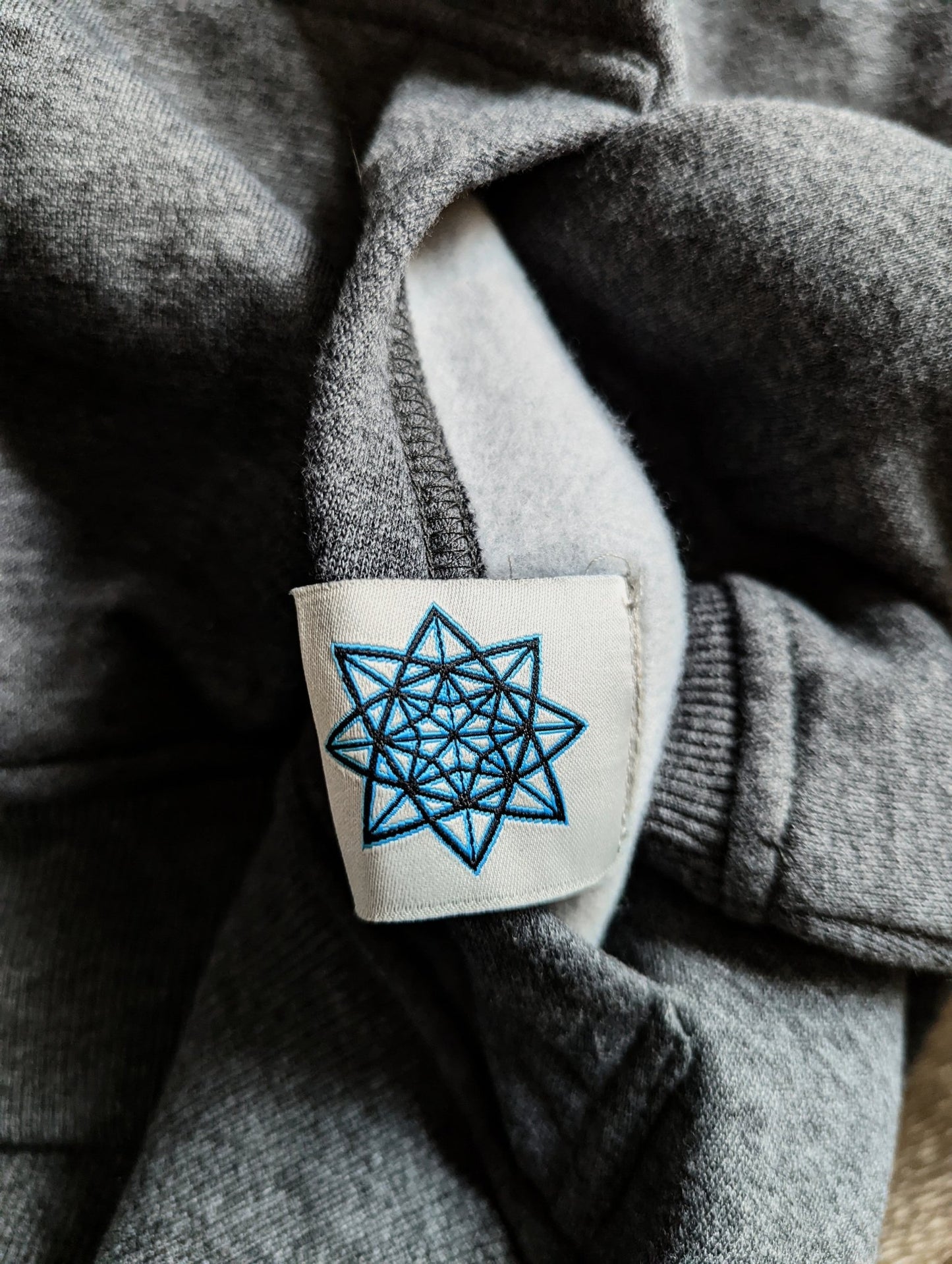 A hidden design inside to add a little extra flair to our hoodie. A hand drawn 8 point star we added to our inside tag.